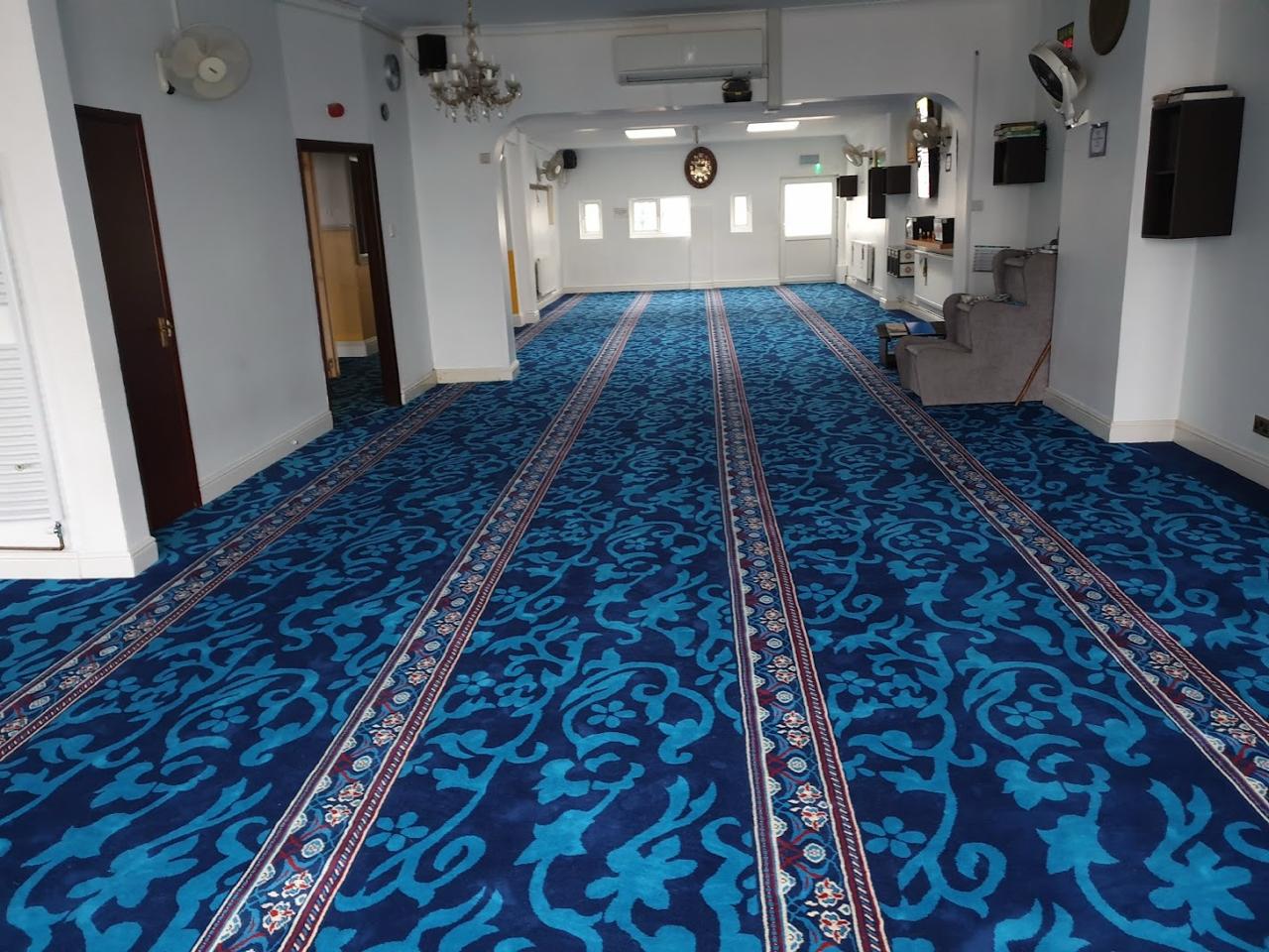 Main prayer hall with teal carpet
